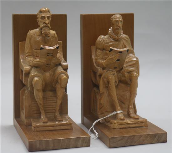 A pair of walnut and boxwood bookends formed as Cervantes and Shakespeare